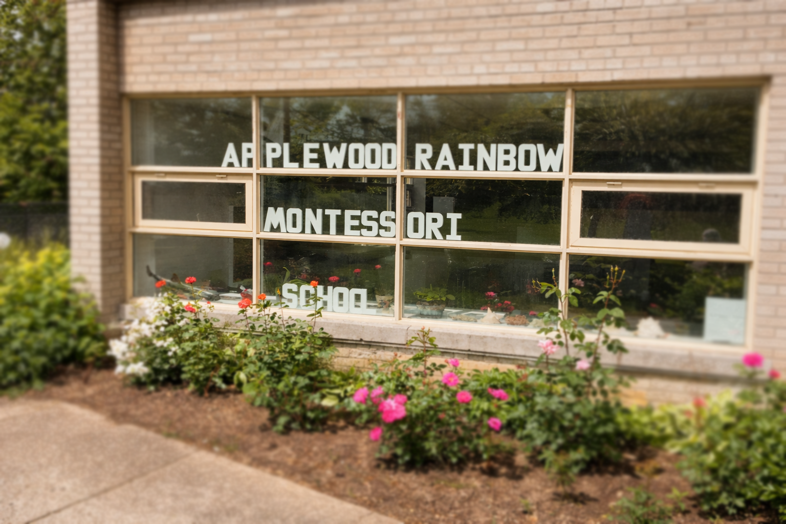 Applewood Rainbow Montessori School exterior with garden beds